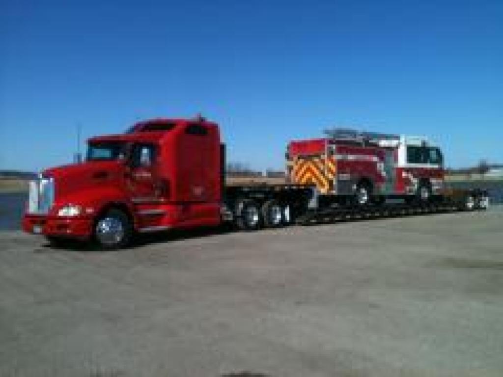 Flatbed Semi-Truck hauling firetruck